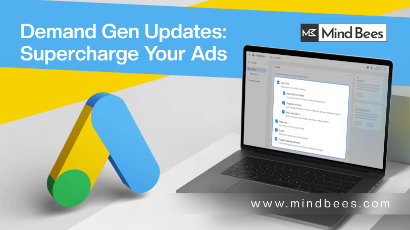 Banner image for MindBees featuring the headline 'Demand Gen Updates: Supercharge Your Ads.' It shows a stylized magnifying glass icon next to a laptop displaying a Google Ads management screen, all set against a bright yellow and blue background. The MindBees logo and website address www.mindbees.